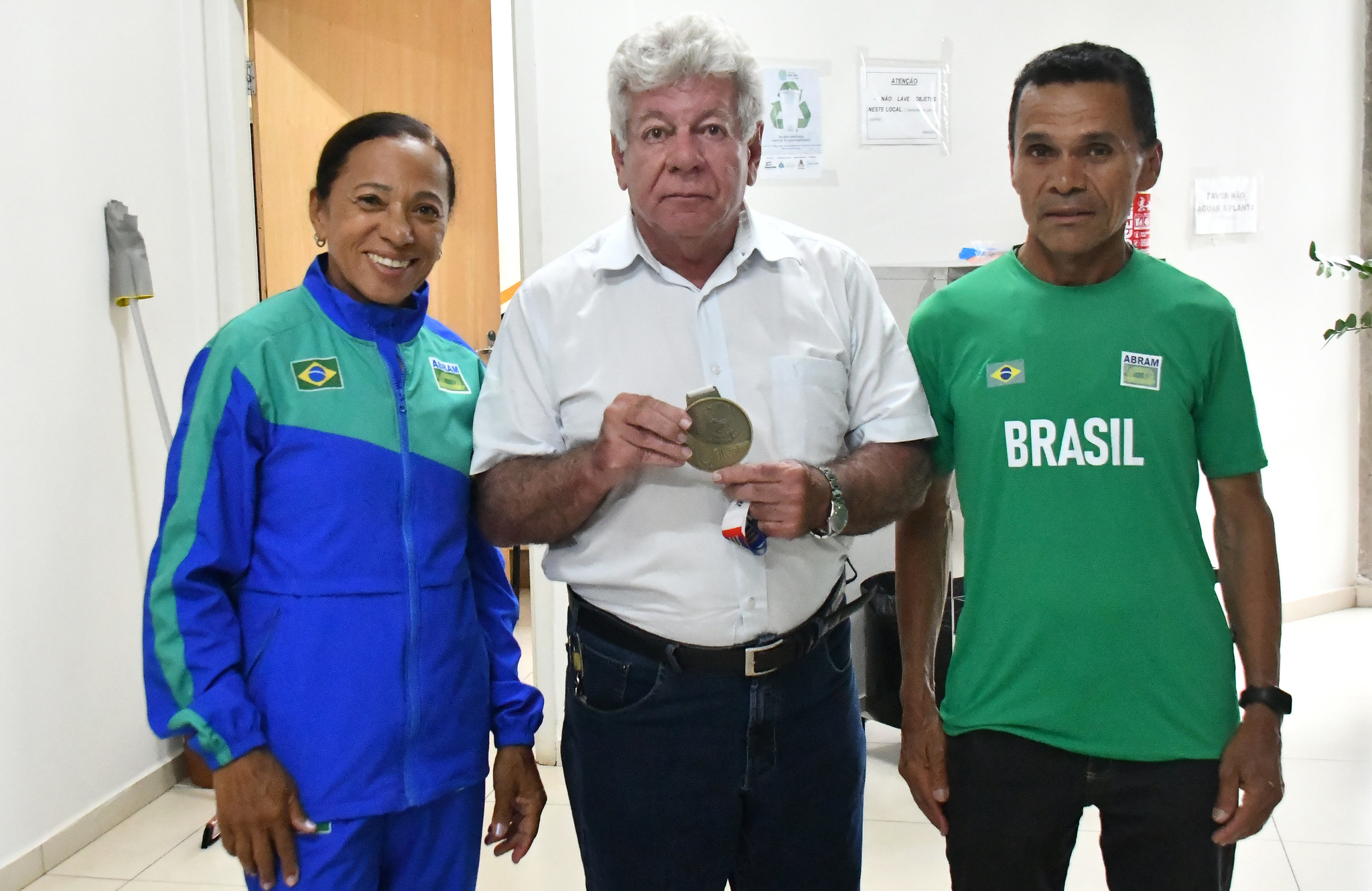 prefeito exibe medalha ao lado dos atletas