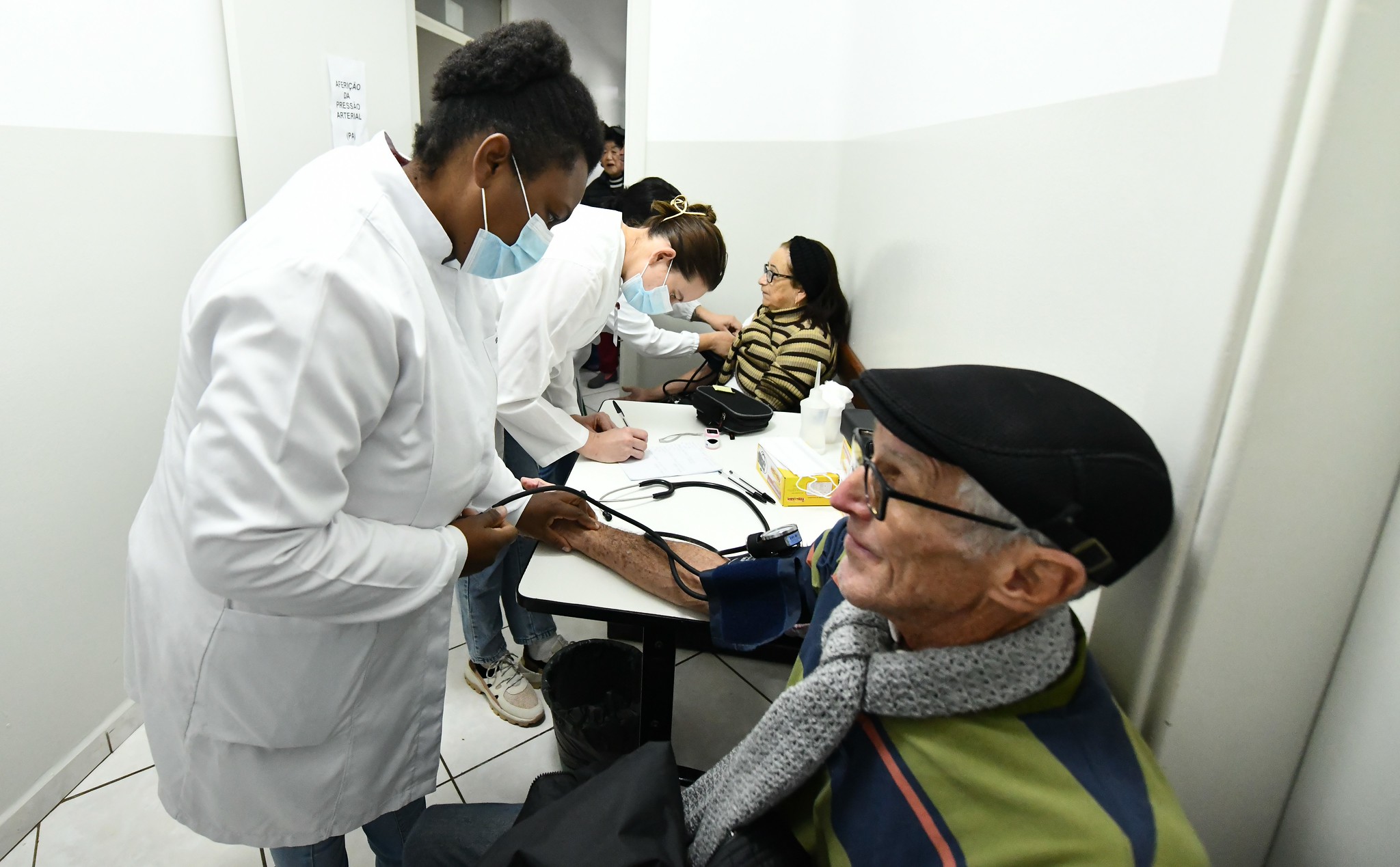 pacientes idosos realizam testes de glicemia e auferem pressão arterial